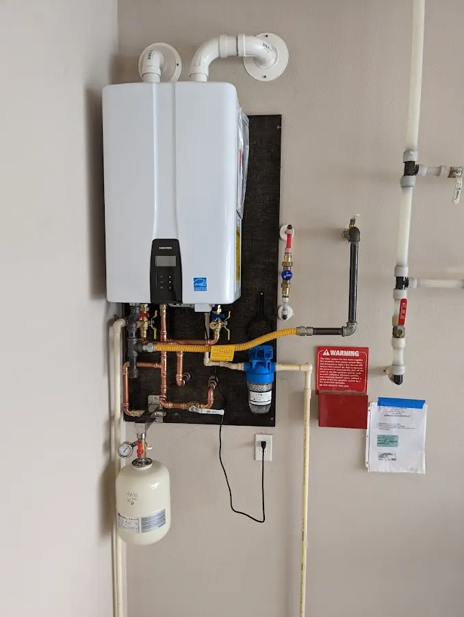 Professional plumber installing copper piping in a Lower Allen home